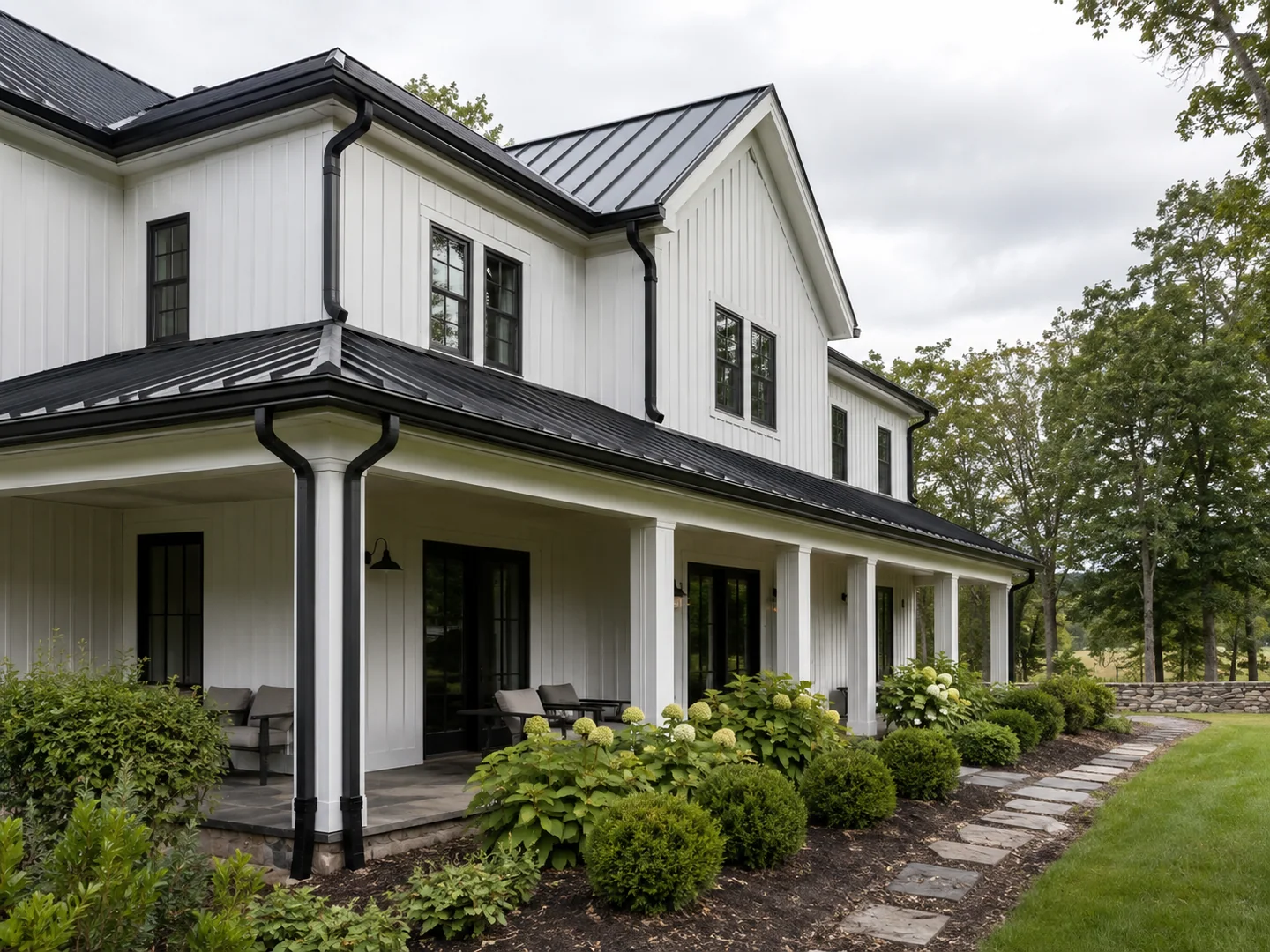 Completed black seamless gutter installation on a modern farmhouse