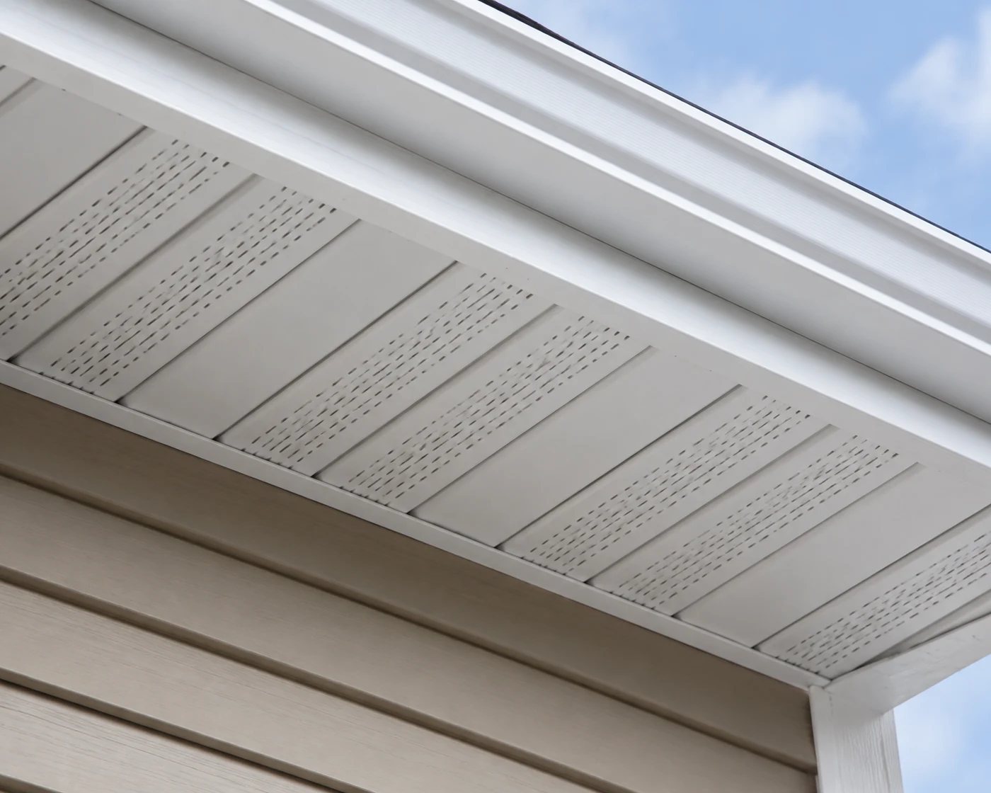 White vinyl Triple 4 vented soffit installed beneath a residential overhang