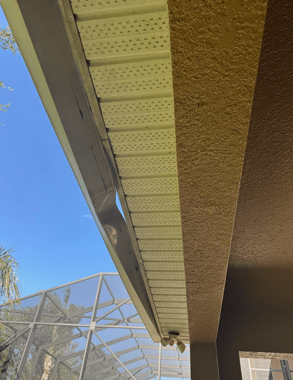 Before: gutter pulling away from the soffit on a stucco home