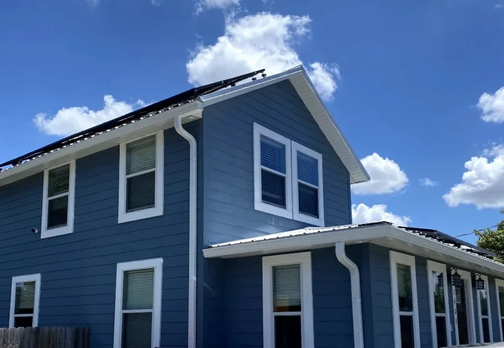 White gutters and downspouts on a blue Pennsylvania home